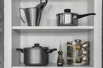 Clean utensils on shelves in kitchen