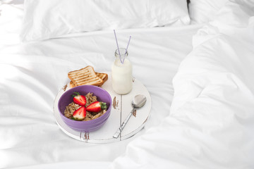 Tasty healthy breakfast on bed