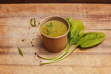 Spinach soup in a craft glass