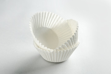 Fototapeta na wymiar Paper cups for baking on white background