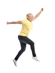 Mature woman jumping against white background