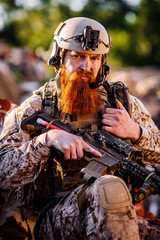 rangers with assault rifles on battlefield background. army, military and people concep