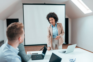 Female boss having meeting with her colleagues.