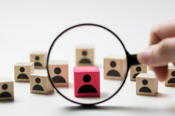 Searching for talent or looking for employee concept using magnifying glass and wooden cube with people icon