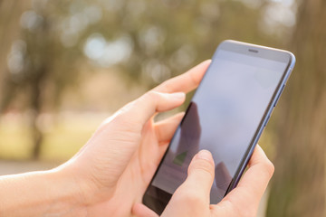 Woman using mobile phone for navigation outdoors, closeup