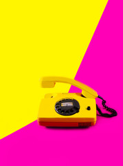 Retro vintage phone handset yellow pink red purple plastic orange disko background old style shadow...