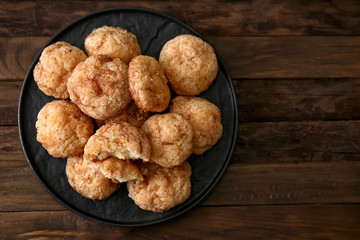 Plate with tasty cookies on wooden table