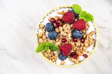 Bowl with cereal,granola, milk and fresh berry fruits