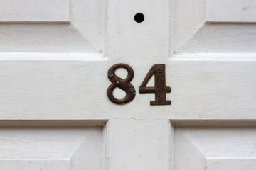House number 84 with the eighty-four on a white door