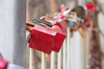 many old locks hang on iron fence