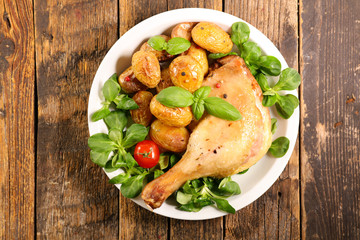 grilled duck leg with lettuce and potato