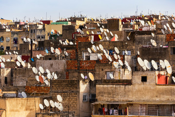 FES, MOROCCO - November 16, 2018: Great amount satellite dishes of parabolic antennas on building...