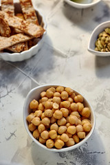 Chickpeas cooked in white bow, on the table ready
