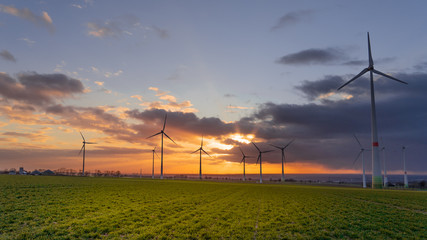 Fototapeta premium Sunset with wind turbines