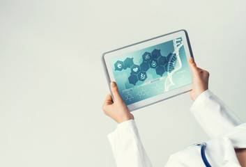 Close of female doctor hands working with tablet pc computer