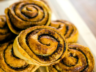 homemade cinnamon buns with caramelized sugar tasty and beautiful, sliced ​​and baked in the oven rolls and black coffee