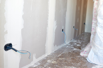 Boxes and cables of new electrical installation. DIY, house indoor improvements room construction