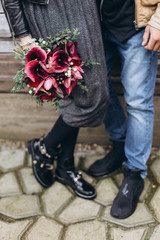 Hipster loving couple standing together with flowers. Family, romantic, love concept
