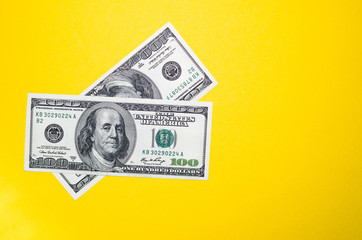 100 dollars on a yellow background