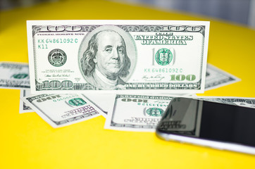 100 dollars on a yellow background