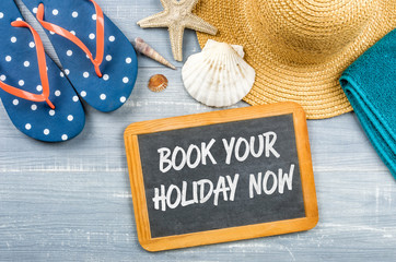 Message on a chalkboard - Book your holiday now