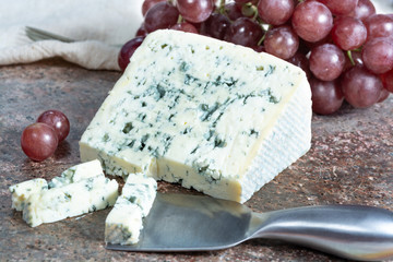 Blue Auvergne semi-hard AOP French blue cheese made from raw cow milk in Auvergne, France served as dessert with grapes