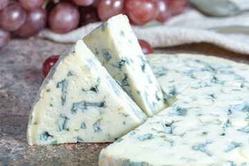 Fourme Ambert semi-hard French blue cheese made from raw cow milk served as dessert with grapes