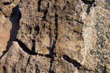 Fototapeta premium Stone coastline. Rocks and water. Natural background. Stone texture of the edge of the water