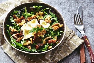 Mushrooms, dried figs and walnut salad with brie cheese. Top view salad isolated