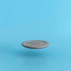 Round levitating a pedestal on a blue background. Stand for your design or text.
