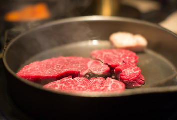 Raw Beef Steak Slices in Pan. Raw Meat Steaks. Three Raw Fresh Beef Steak. Closeup Blur Bokeh. Beef Steaks on the Grill. Dark Background. Gourmet Restaurant. Premium High End Dining. Luxury Dinner.