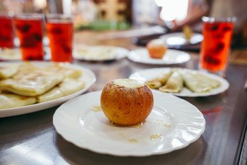 Baked apple served with pancakes and juice