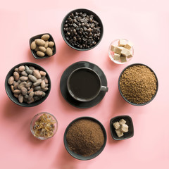 Concept of coffee, cacao beans and sugar on pink background.