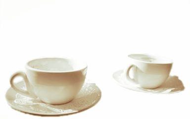 Two white porcelain coffee cups.