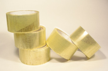 Several rolls of transparent packaging, scotch tape, photographed on white