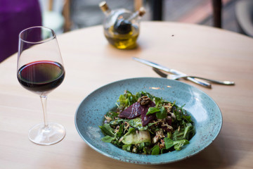Vegeterian salad on table with red wine
