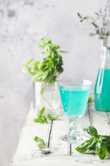 Colorful refreshing summer drink with basil seeds on light background.