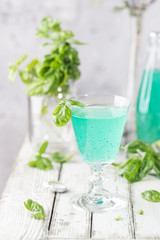 Colorful refreshing summer drink with basil seeds on light background.