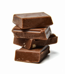 Small chocolate bars stacked on a white isolated background. Close-up. Side view.