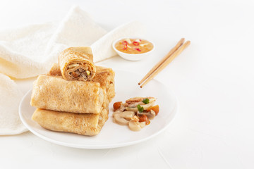 Chinese tortillas - bings in plate with mushrooms on a white background. Copy space
