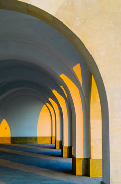 Corridor Colonnade Arcade Perspective Architectural Background. Arched Vaults in Architecture.Building Exterior at Sunset