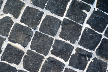 Black Granite Cobblestone Texture with White Seams. Black Chopped Cobbles Background.