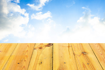 The blur cool blue sky white cloud with old Wooden table