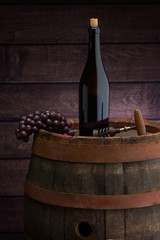 red wine bottle  on wodden barrel