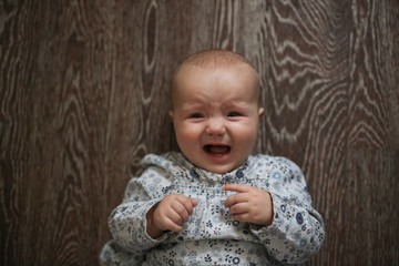 baby sad rubs his eyes and is grooved, naughty