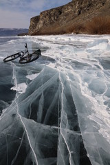 Bicycle in iced Baikal lake near island