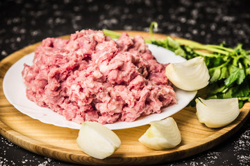 Raw minced pork on white plate