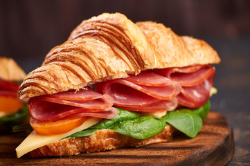Sandwiches on a dark and gray wooden background.