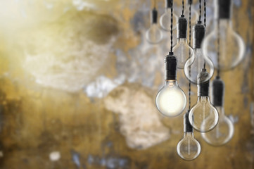 Idea and leadership concept Vintage  bulbs on wall background