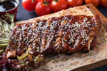  Roasted pork ribs with sesame. Barbeque spicy ribs.  Tasty pork ribs. Closeup